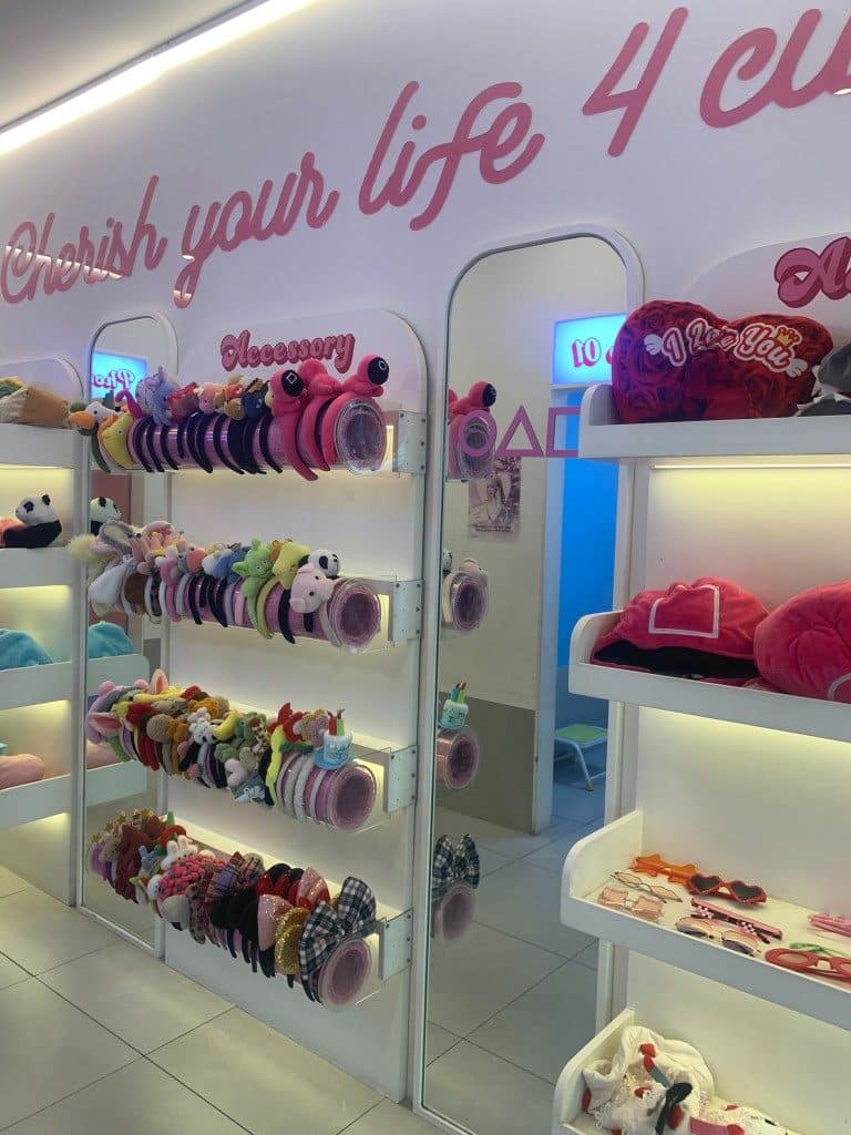 Life4Cuts Hongdae props wall with headbands, sunglasses, and plush accessories