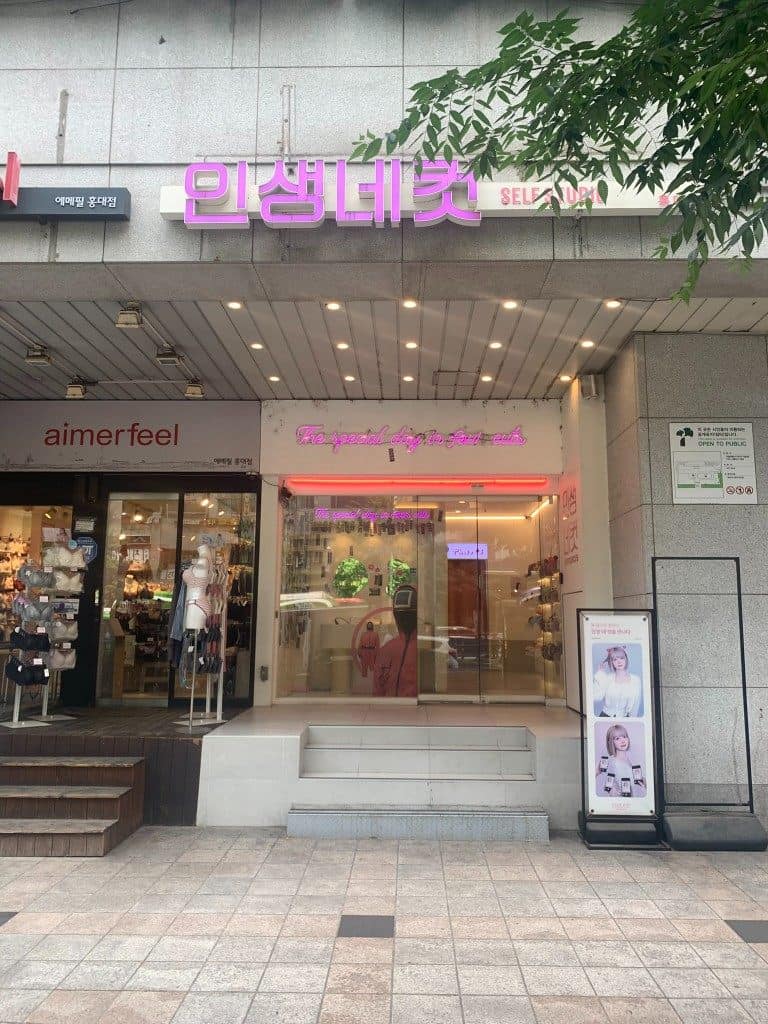 Life4Cuts Hongdae storefront with pink neon Insaeng Necut sign