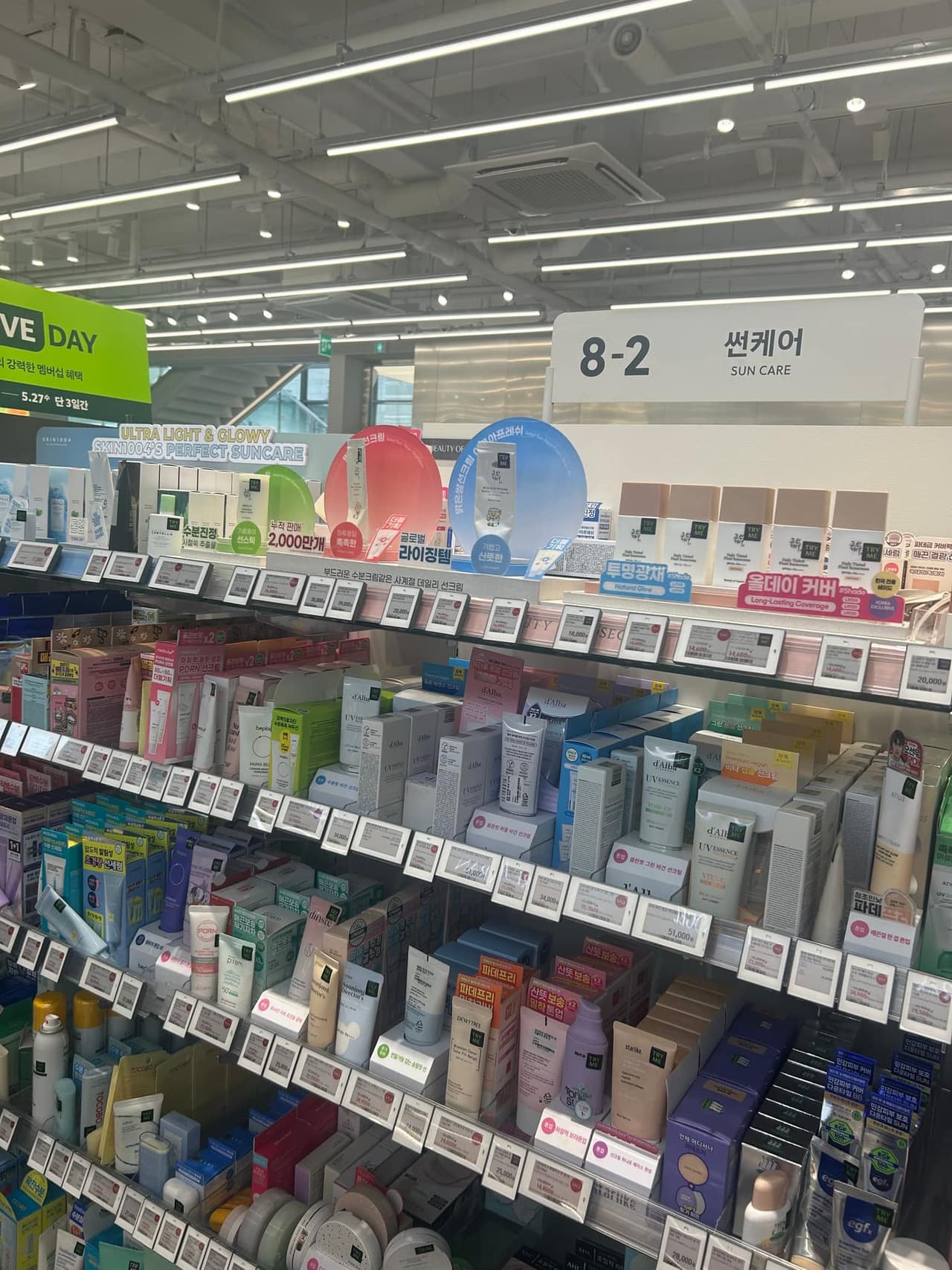 Suncare shelf inside Olive Young Hongdae with Round Lab sunscreen display