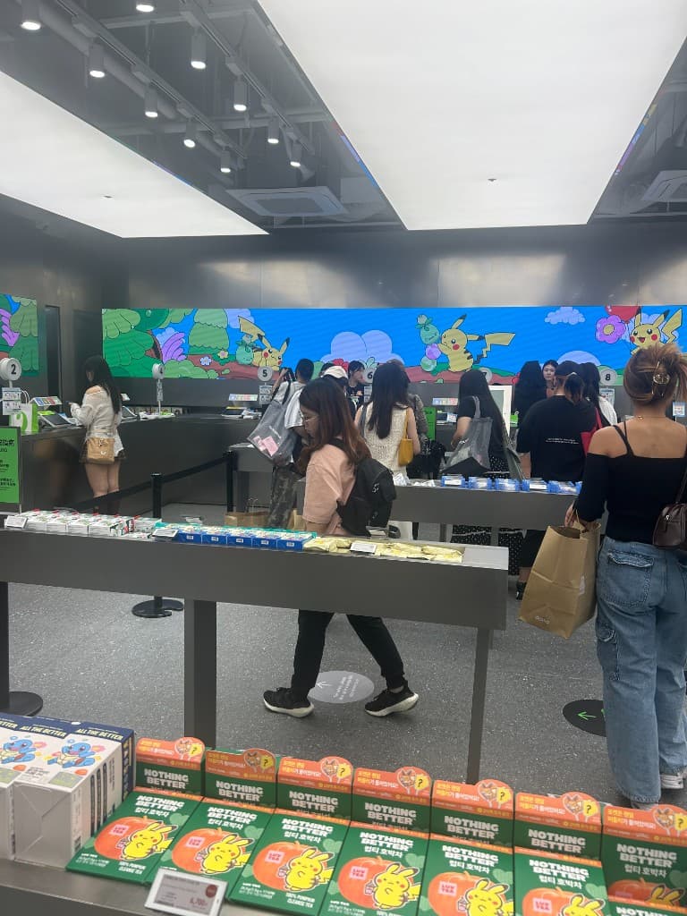 Checkout counter at Olive Young Hongdae Town with Pokemon collaboration display behind the cashier area